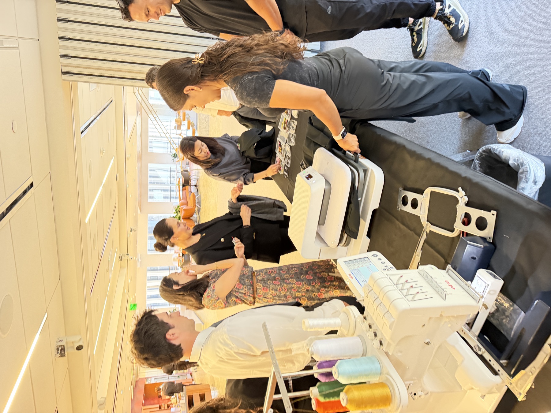 Guests watching live Nike apparel embroidery and patch application at a Century City activation