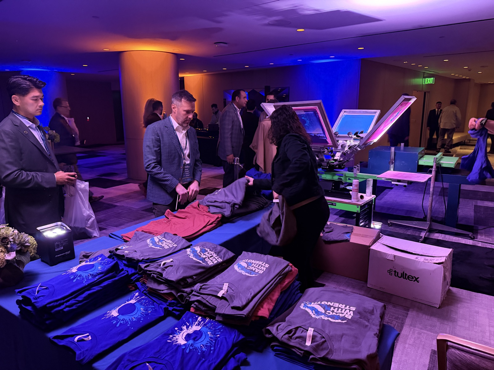 Merch Troop crew running a live production station